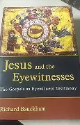 A close-up image of an open Bible with an eye symbol